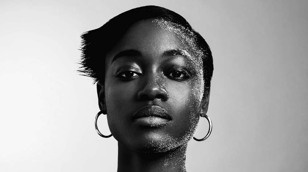 Black and white image from Khiry of a model with short hair wearing Khiry Khartoum hoop earrings.