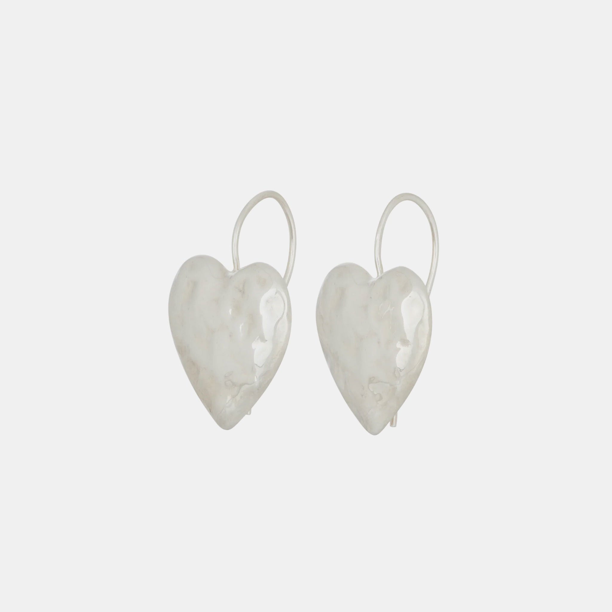 Close side detail photo of the Heart Burn Earrings - White Bronze.