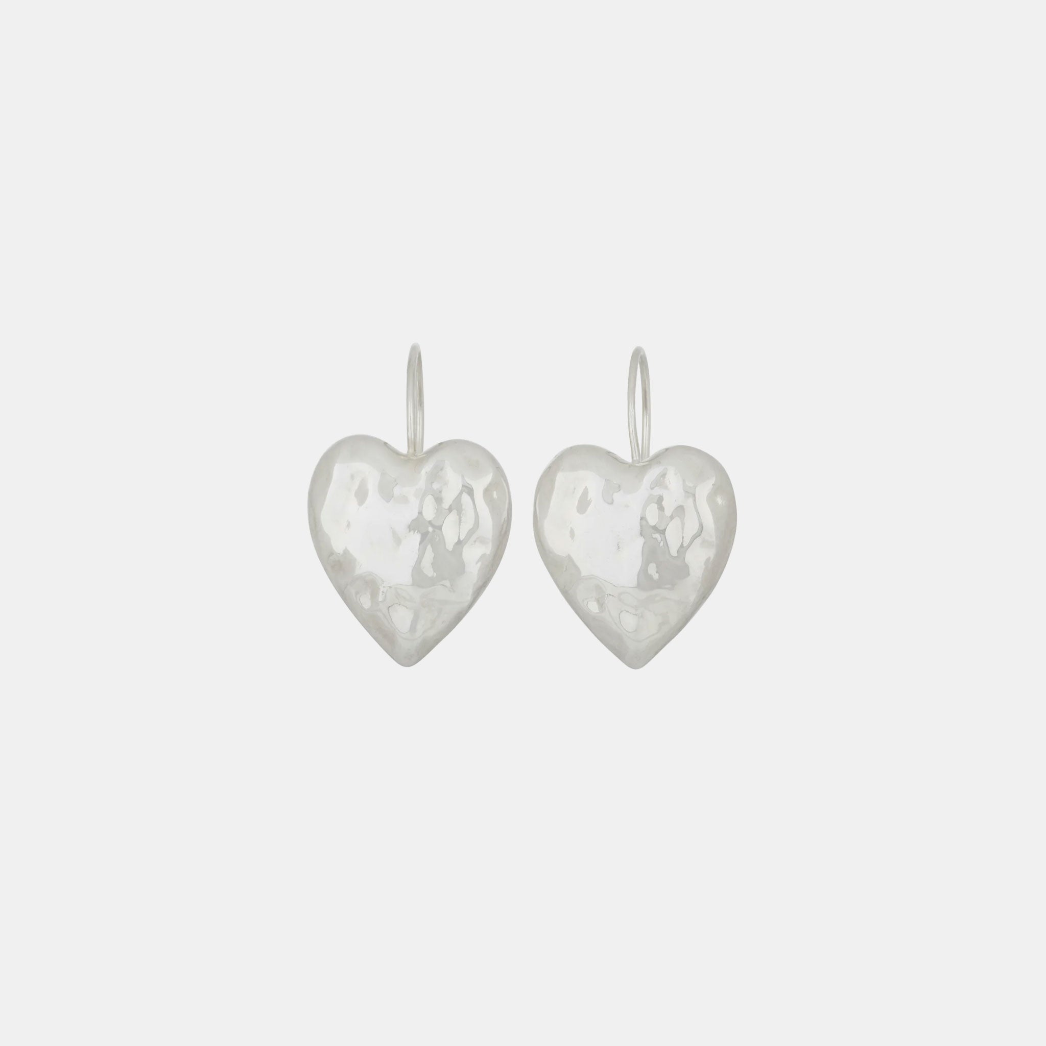Flat detail photo of the Heart Burn Earrings - White Bronze.