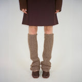 Front photo of model wearing the brown leg warmers paired with brown ballet flats and a brown skirt.