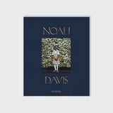 Navy blue cloth-bound cover for Noah Davis: In Detail featuring a painting by American artist Noah Davis.