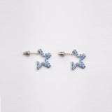 Small sterling silver earrings in the shape of a 5-pointed star with tiny blue rhinestones.