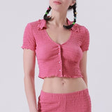 Close half body photo of model wearing the V-Neck Ruched Polo Top - Dark Rose.