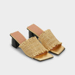 Gold heeled slide with black block heel, square toe, and gold upper, with smocked gold vamp - top down angled view.