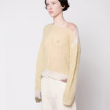 Side half body photo of model wearing the Composition Sweater - Sand.