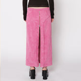 Back half body photo of model wearing the Cord Zip Skirt - Pitaya.