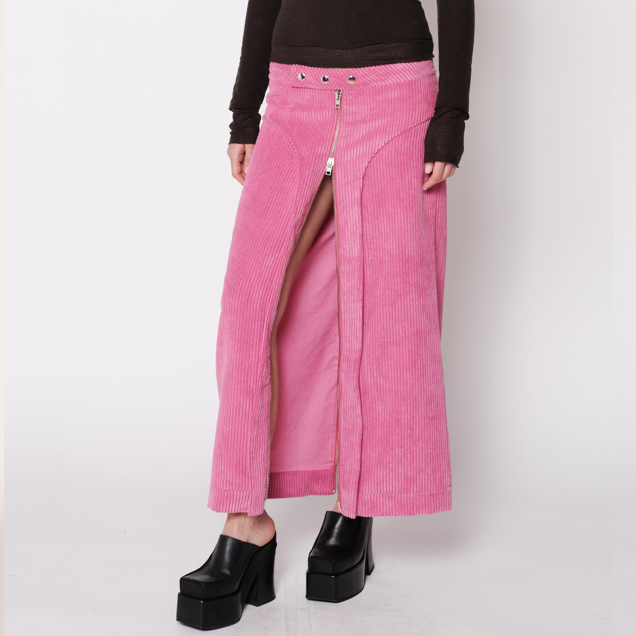 Close half body photo of model wearing the Cord Zip Skirt - Pitaya.