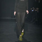 Close half body runway photo of model wearing the Eclipse Skirt - Stone.