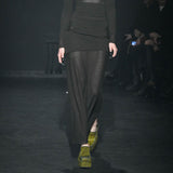 Close half body runway photo of model wearing the Eclipse Skirt - Stone.