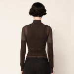 Back half body photo of model wearing the Eclipse Turtleneck - Stone.