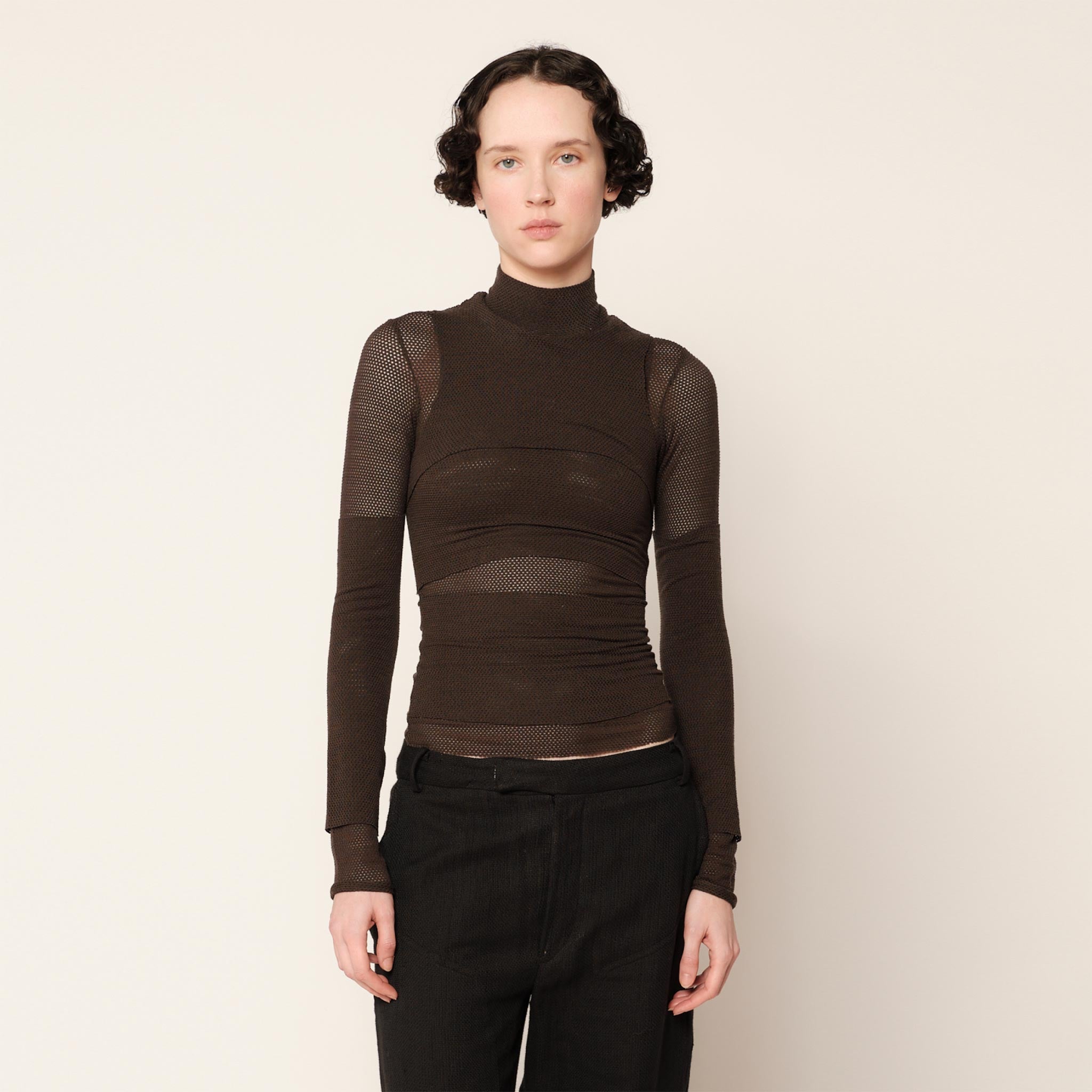 Close half body photo of model wearing the Eclipse Turtleneck - Stone.