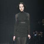 Close half body runway photo of model wearing the Eclipse Turtleneck - Stone.