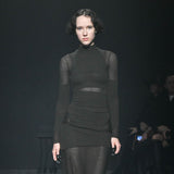 Close half body runway photo of model wearing the Eclipse Turtleneck - Stone.