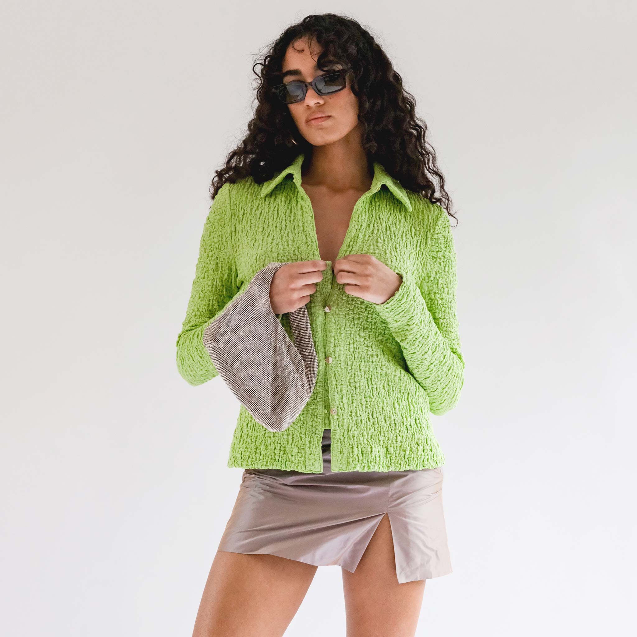 Close half body photo of model wearing the Lowry Top - Acid Green.