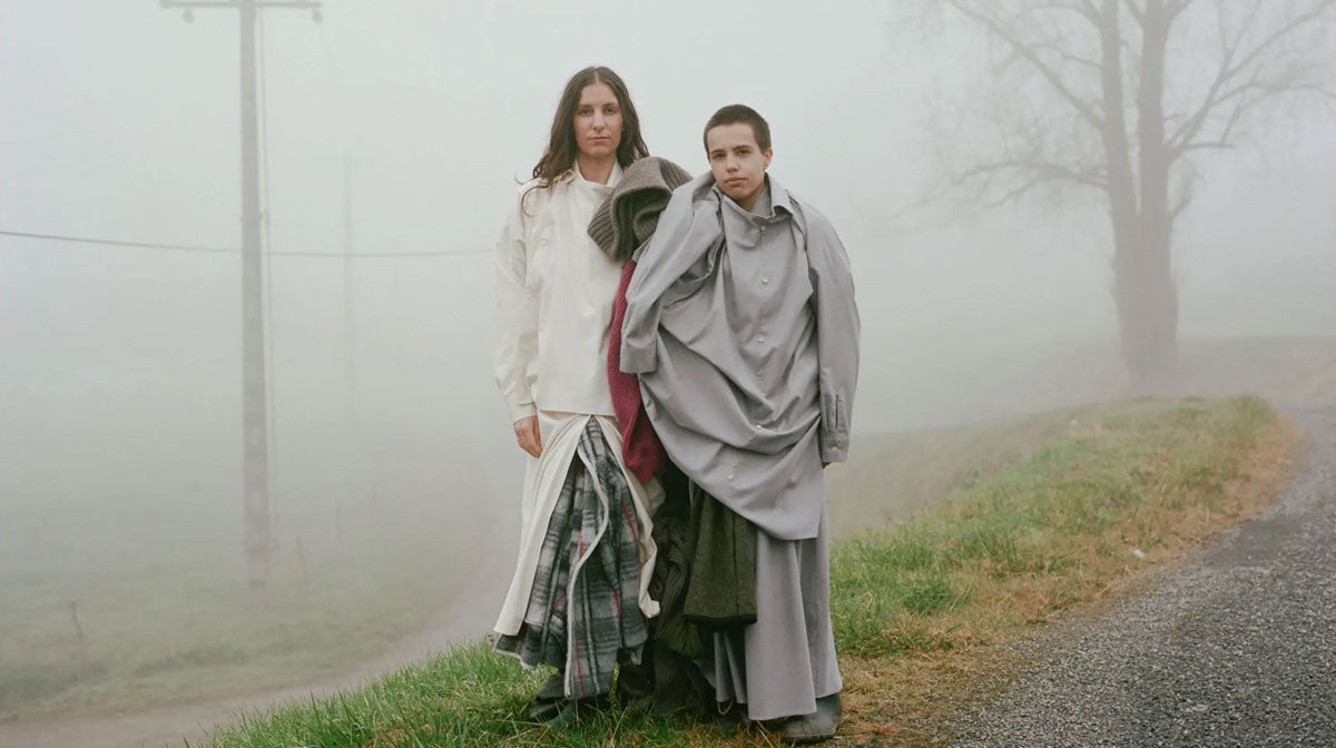 Lookbook image from Baserange showing 2 people wearing layered Baserange garments.