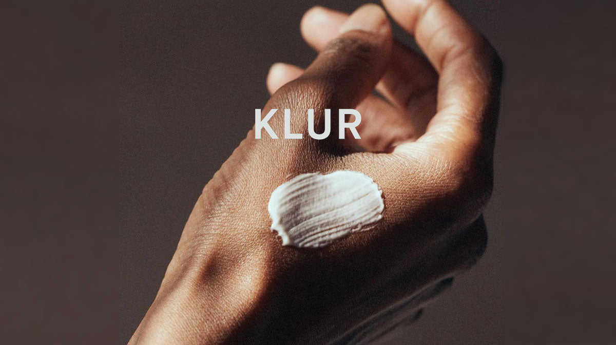 Photograph of a woman's hand with a dab of KLUR moisturizing cream.