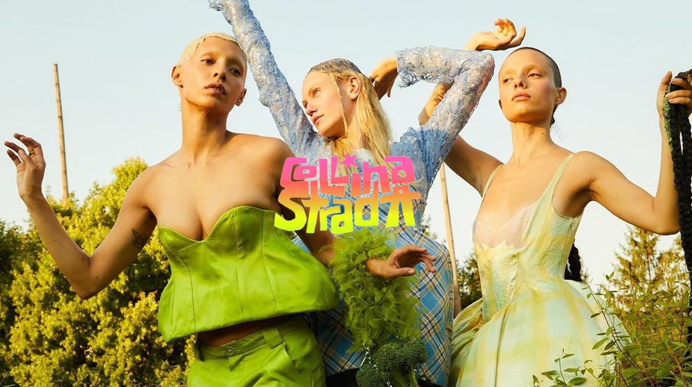 3 models pose wearing Collina Strada runway outfits with their arms raised to the sky.