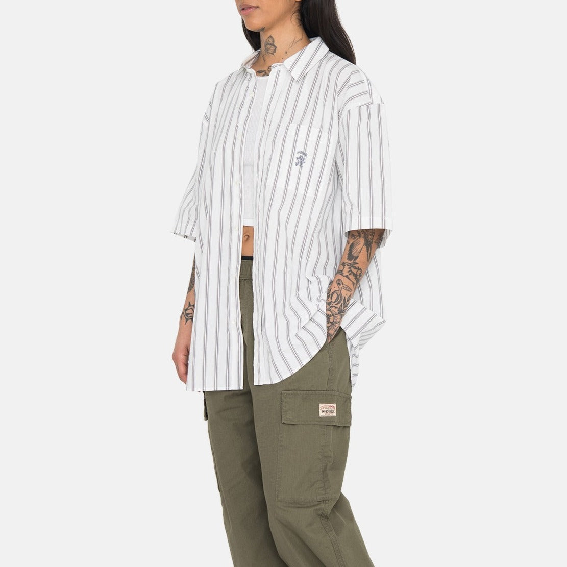 Side photo of the model wearing the Boxy Striped SS Shirt - Off White Stripe.