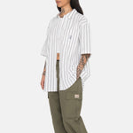 Side photo of the model wearing the Boxy Striped SS Shirt - Off White Stripe.