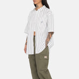 Side photo of the model wearing the Boxy Striped SS Shirt - Off White Stripe.