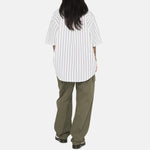 Back full body photo of model wearing the Boxy Striped SS Shirt - Off White Stripe.