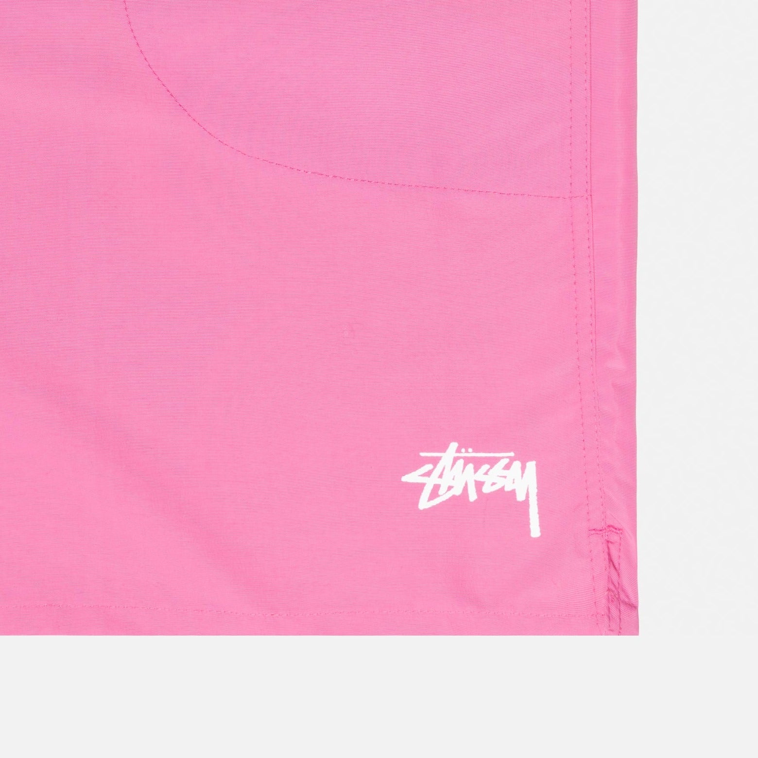 Detail photo of the stussy logo on the Stock Water Short - Gum Pink.