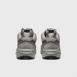Silver Metallic and grey athletic shoe featuring breathable angled openings on lateral and medial sides and a chunky gripping sole - rear view.