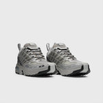 Silver Metallic and grey athletic shoe featuring breathable angled openings on lateral and medial sides and a chunky gripping sole - front angled view.