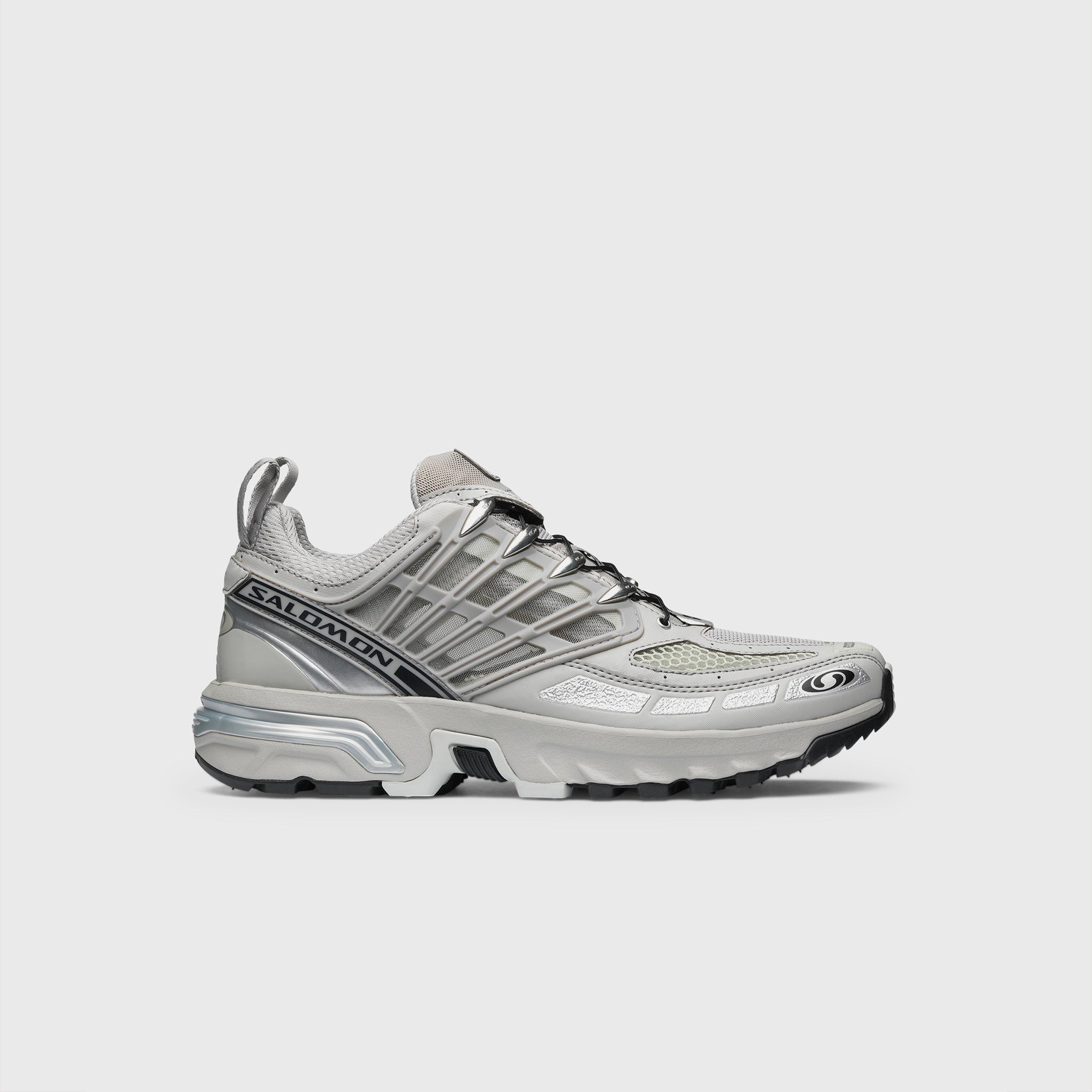 Silver Metallic and grey athletic shoe featuring breathable angled openings on lateral and medial sides and a chunky gripping sole - side view.