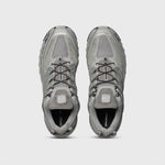 Silver Metallic and grey athletic shoe featuring breathable angled openings on lateral and medial sides and a chunky gripping sole - top down view.
