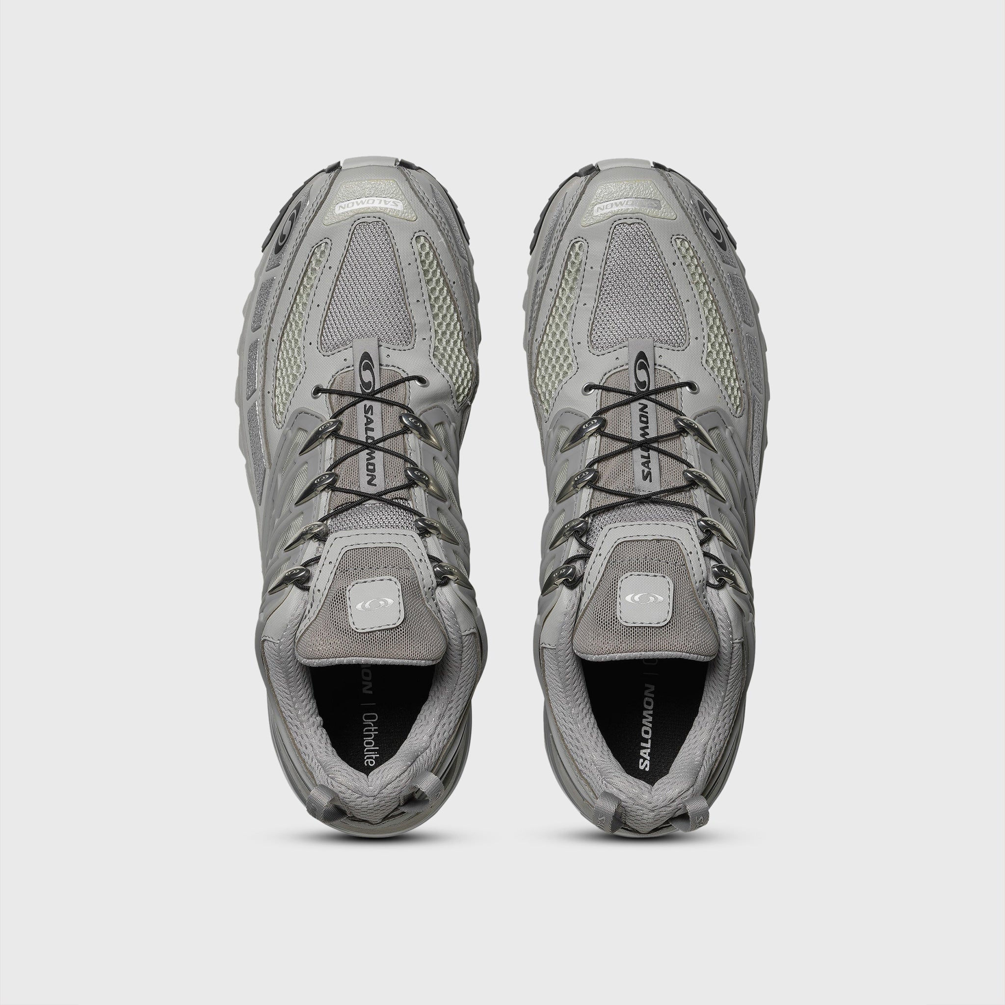 Silver Metallic and grey athletic shoe featuring breathable angled openings on lateral and medial sides and a chunky gripping sole - top down view.