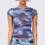 A model wears the blue and white graphic printed mesh Arc top, with ruching details along the chest and shoulders, front view.