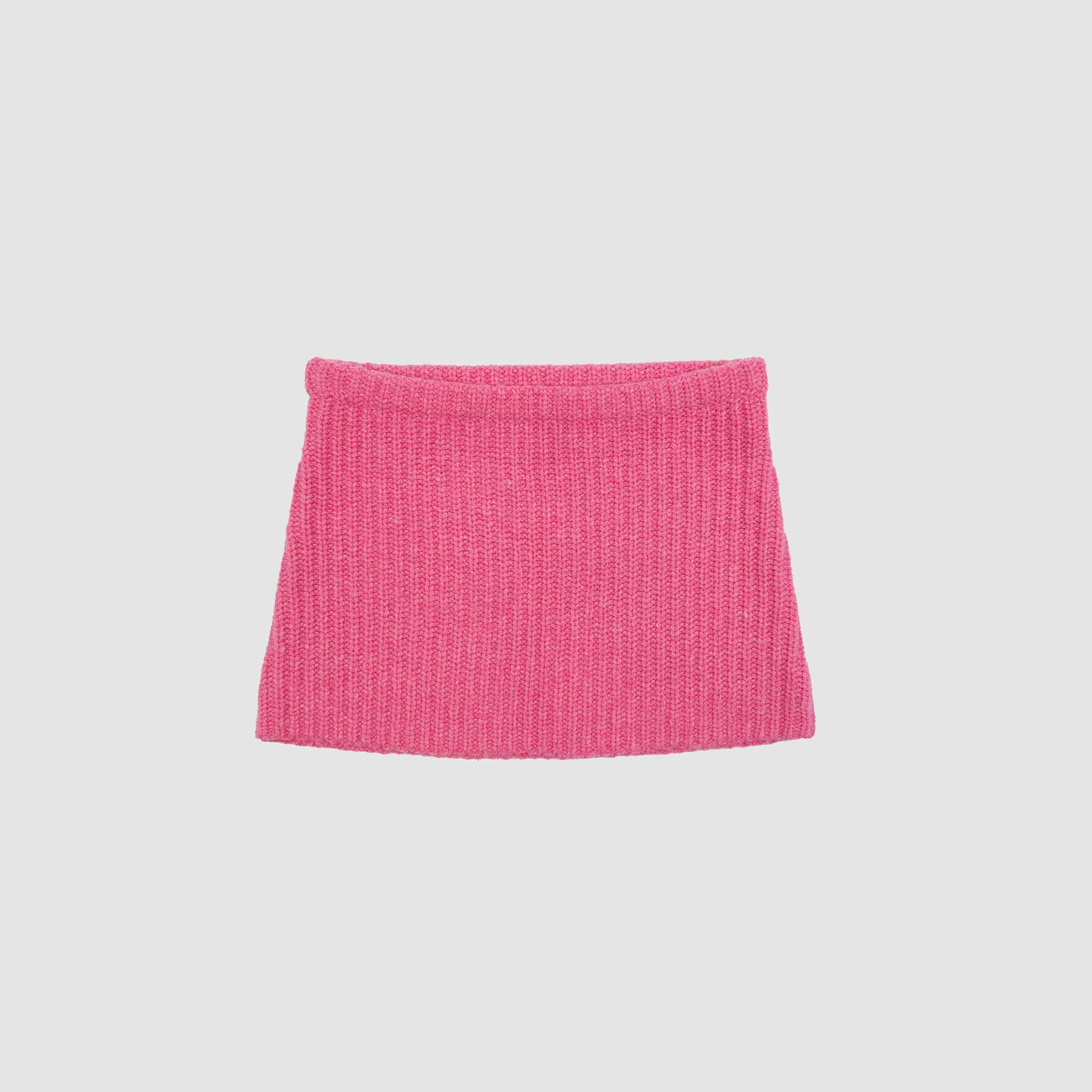 Flat photo of the Barb Skirt - Carnation. The skirt is a pink mini knit skirt.