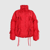 Flat photo of the Bommy Jacket in red. The jacket features bow details ruching all over the jacket.