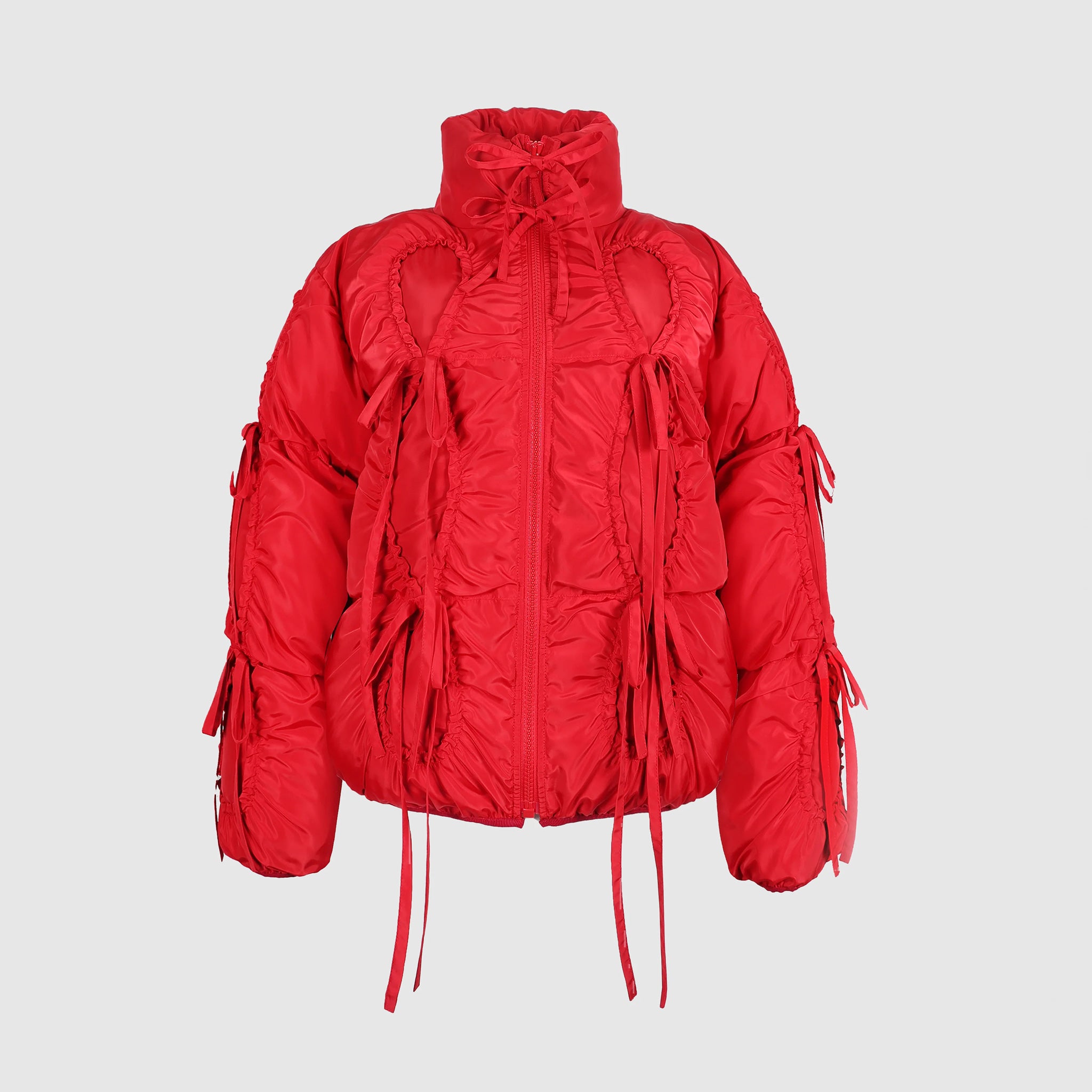 Flat photo of the Bommy Jacket in red. The jacket features bow details ruching all over the jacket.