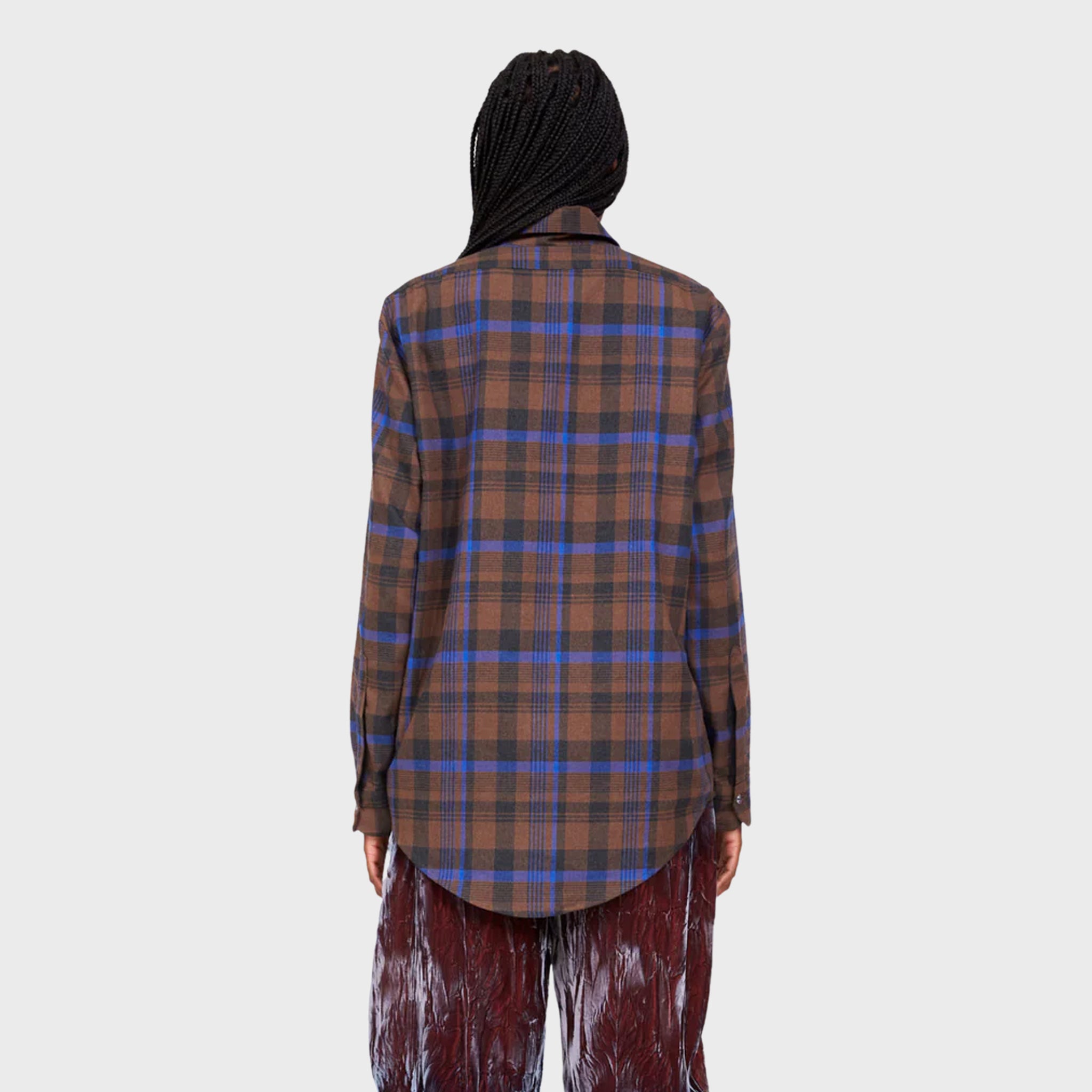 Back half body photo of model wearing the bunny button up - in brown plaid. 