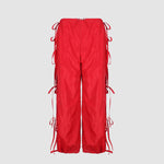 Flat photo of the Cam Pants - Red, featuring red bows down the side of the pants.