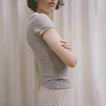 Side half body photo of model wearing the Campos Tee - Smoke.