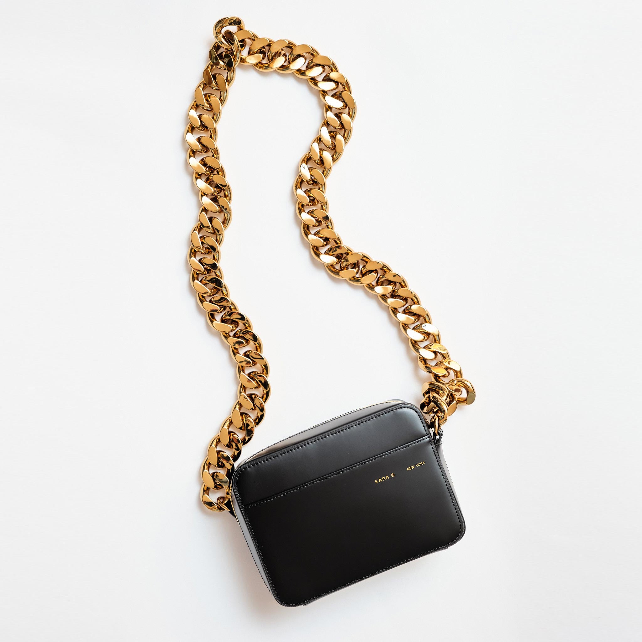 The black leather camera bag by KARA with heavy gold chain strap.