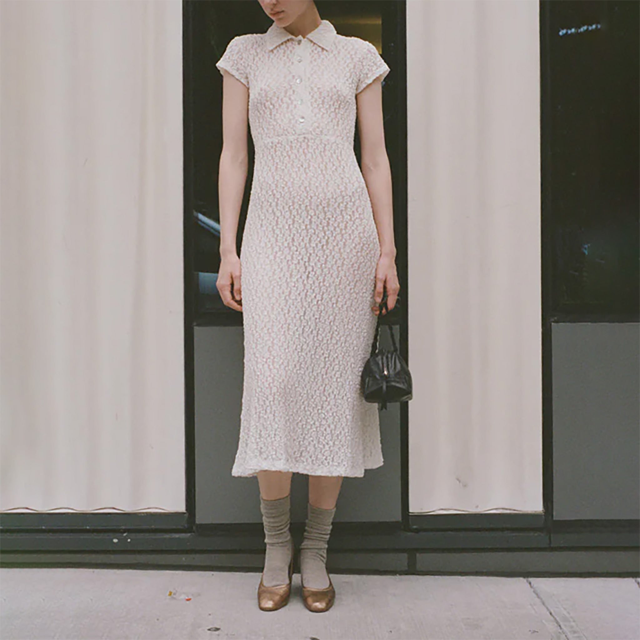 Full body photo of model standing in the street wearing the Choice Dress - Ivory.