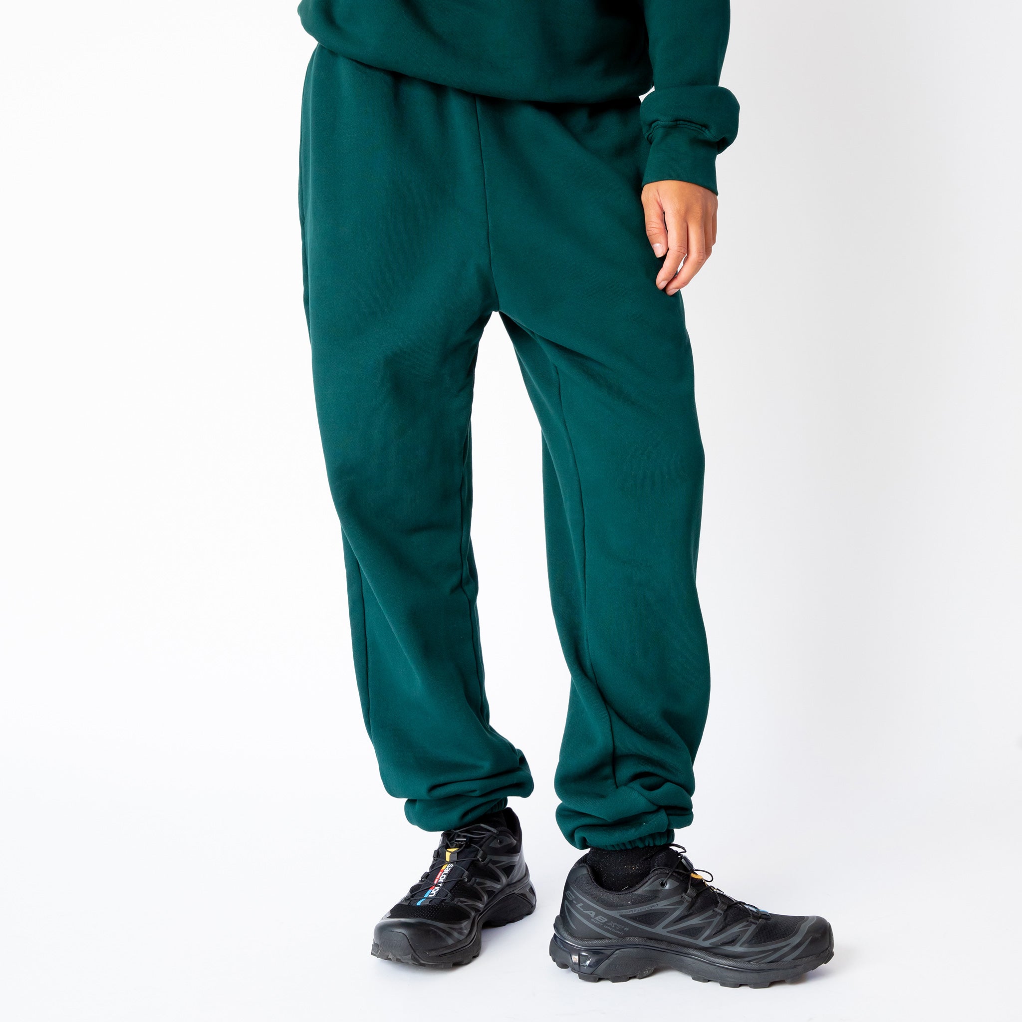 A model wears the classic sweatpant by Les Tien in an emerald green color - front view.