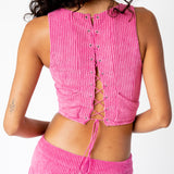 Detailed back photo of the pink corduroy Cord Bustier by Eckhaus Latta, showing the pink laced detailing going down the entire back of the garment.