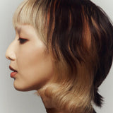 Side profile photo of model wearing the Cream Highlight Stick - Perla.