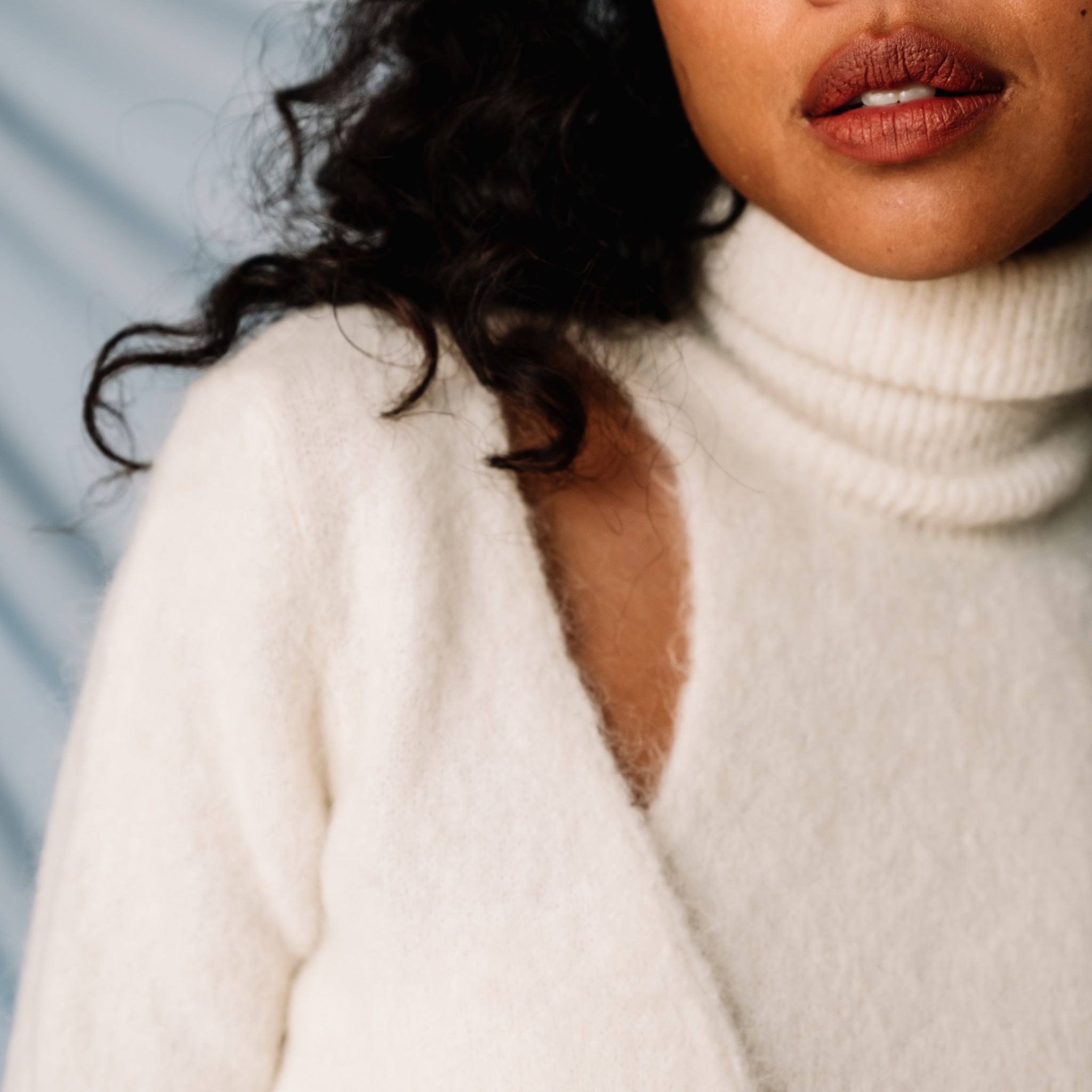 Detailed photo of the clavicle cutouts in the Ganni Brushed Alpaca Wrap Sweater.