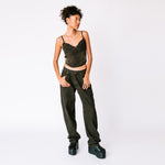 A model wears the baggy faded black Echo Jeans by Miaou, paired with the matching strappy Kiko corset, full outfit view.