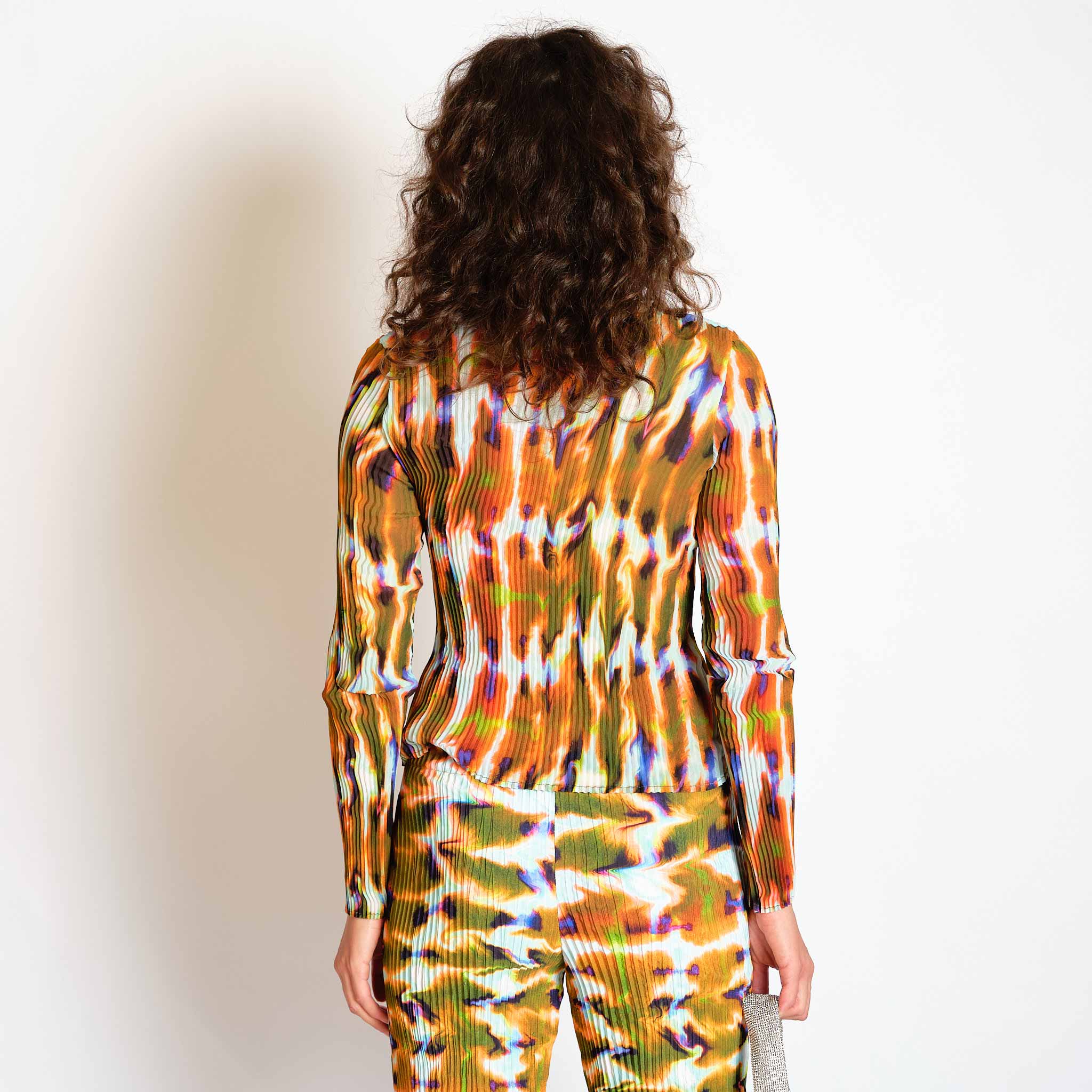 A model wears the orange and green graphic Eddie top - back view.