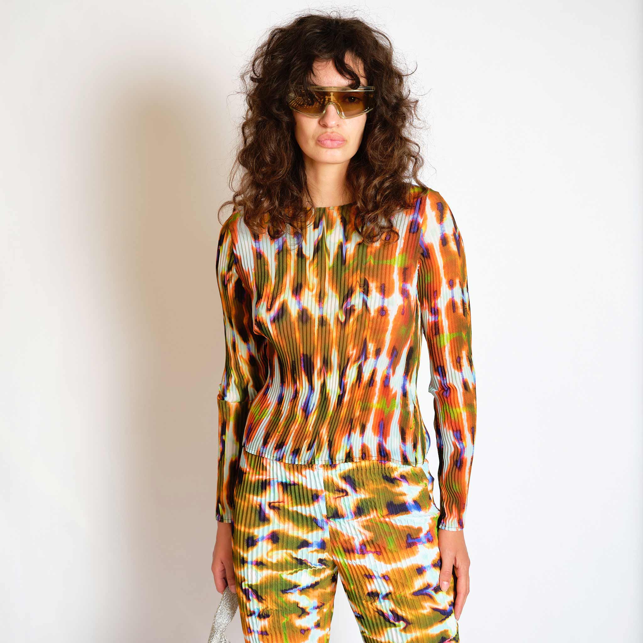 A model wears the orange and green graphic Eddie top - front view.