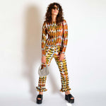 A model wears the orange and green graphic Eddie top - full outfit view.