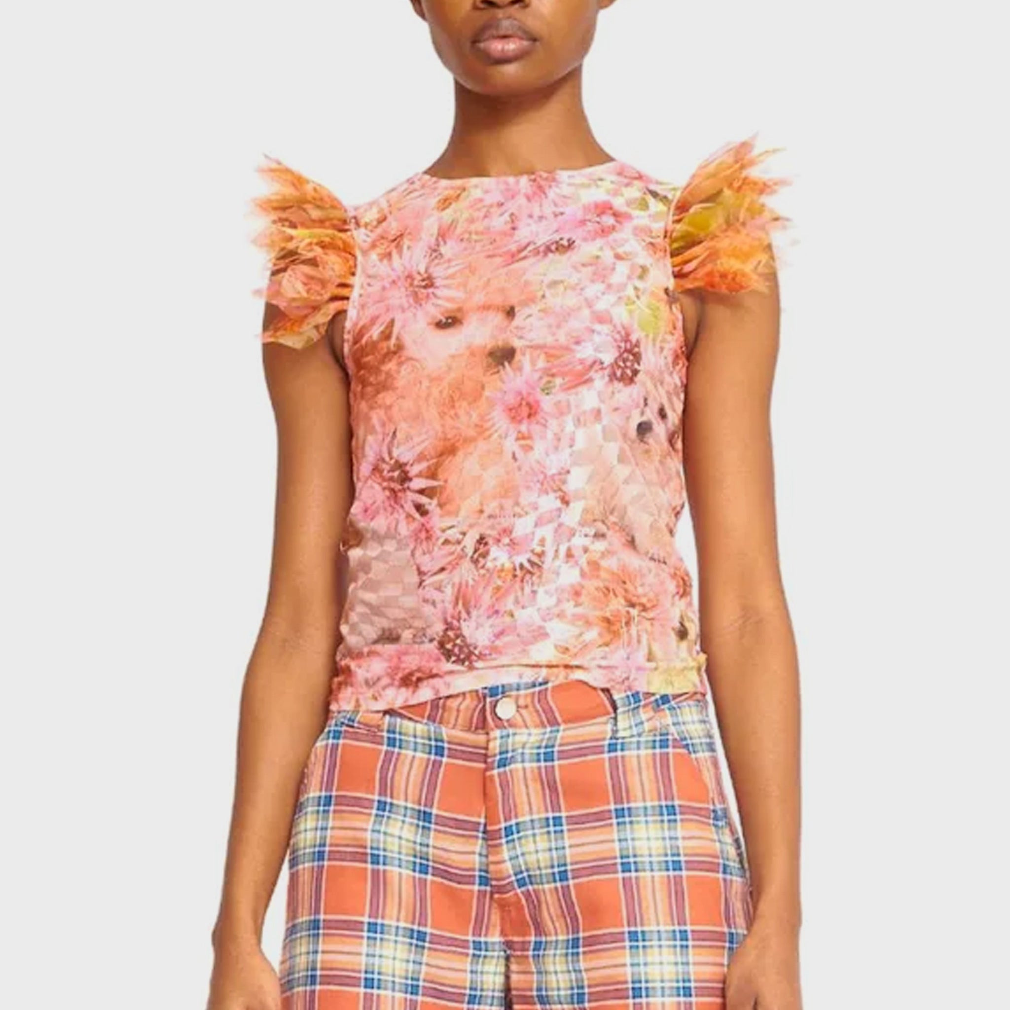 A model wears a fitted tank top in pink checked and printed mesh lace with ruffled shoulder details - front view.