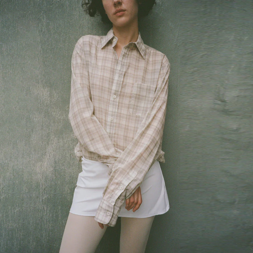 Close half body photo of model wearing the Sheer Foundation Button Down - Greige.